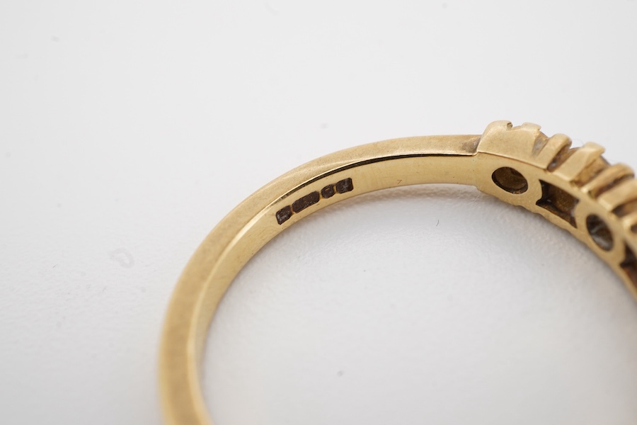A modern 18ct gold and seven stone diamond set half hoop ring size O, gross weight 3.2 grams.